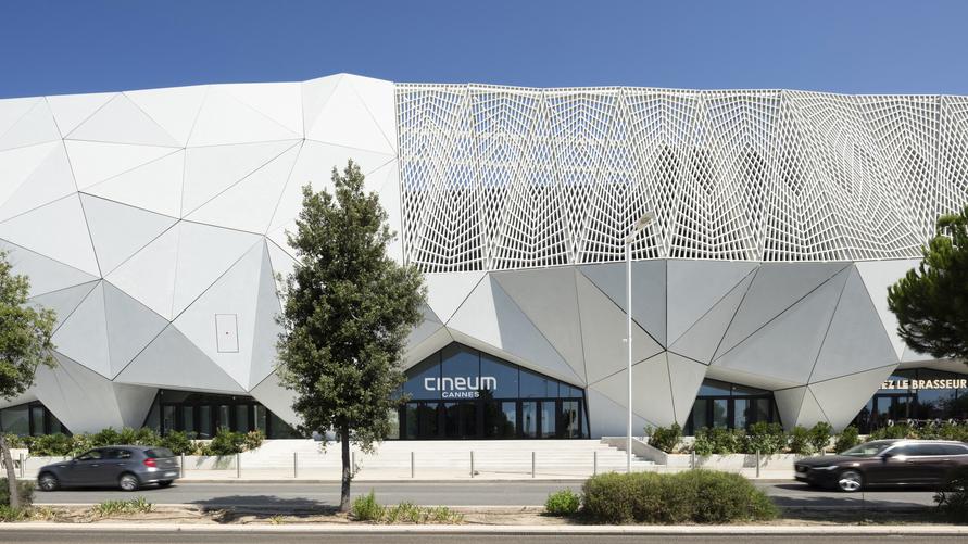Architectural UHPC facade of Cineum Cannes with polygonal and lattice elements.